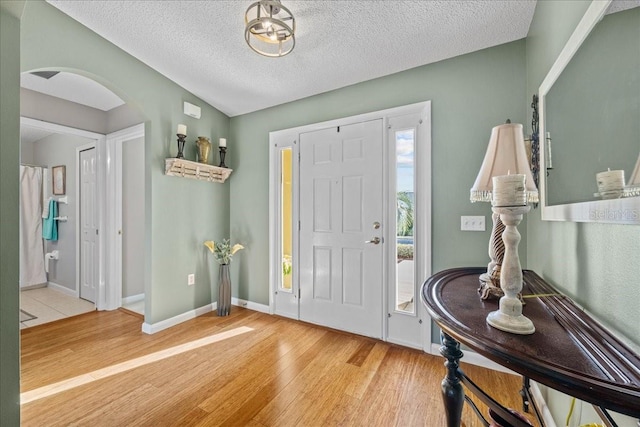 entrance foyer with a textured ceiling and light wood-type flooring