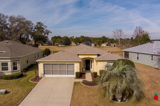 single story home with a garage and a front yard