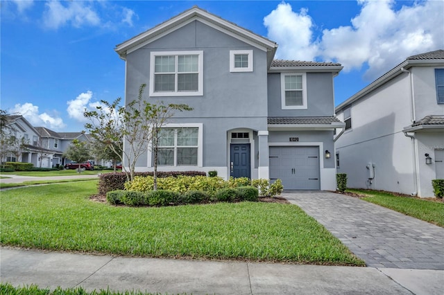 view of front of property with a garage and a front yard