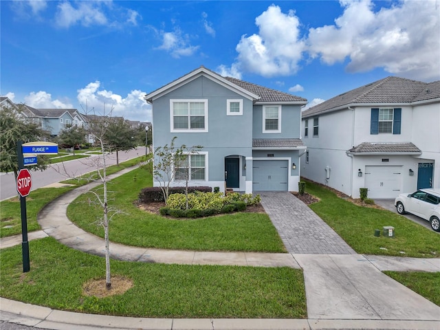 view of front of property with a garage and a front yard