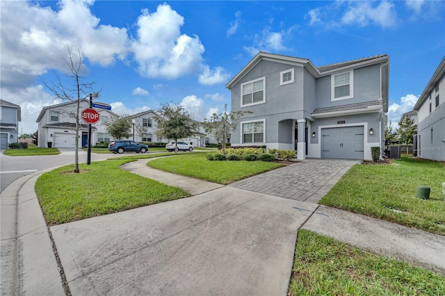 view of property featuring cooling unit, a front yard, and a garage