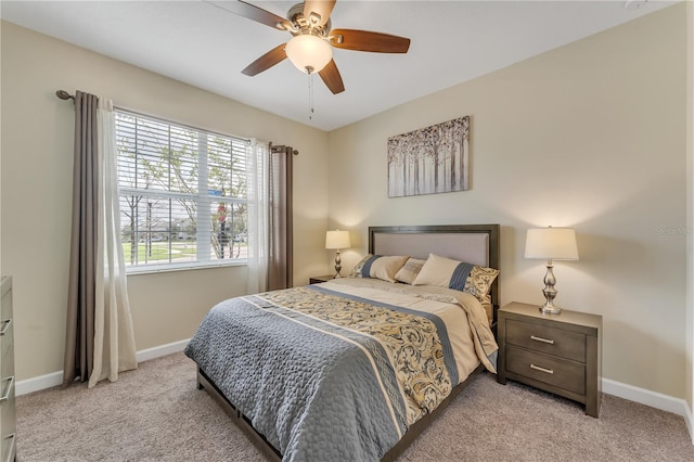 bedroom featuring light colored carpet and ceiling fan