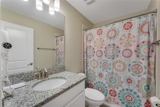 bathroom featuring vanity, toilet, and a shower with shower curtain