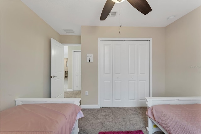 bedroom featuring light colored carpet, ceiling fan, and a closet