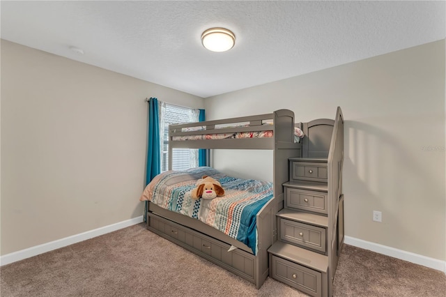 carpeted bedroom featuring a textured ceiling