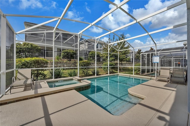 view of swimming pool with glass enclosure and a patio area