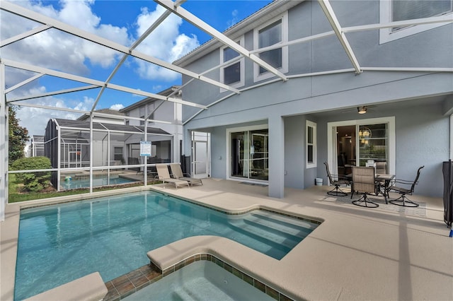 view of swimming pool featuring glass enclosure and a patio area