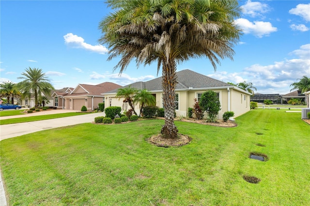 ranch-style home featuring a garage, a front yard, and cooling unit