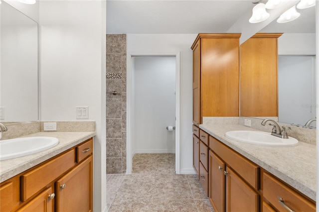 bathroom featuring vanity, a shower, and tile patterned floors