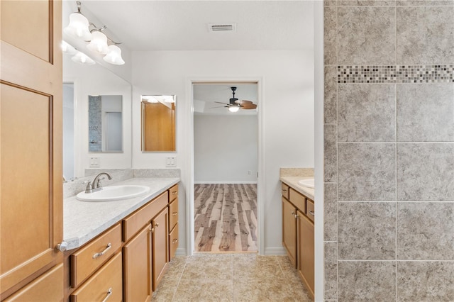 bathroom featuring vanity, ceiling fan, and wood-type flooring