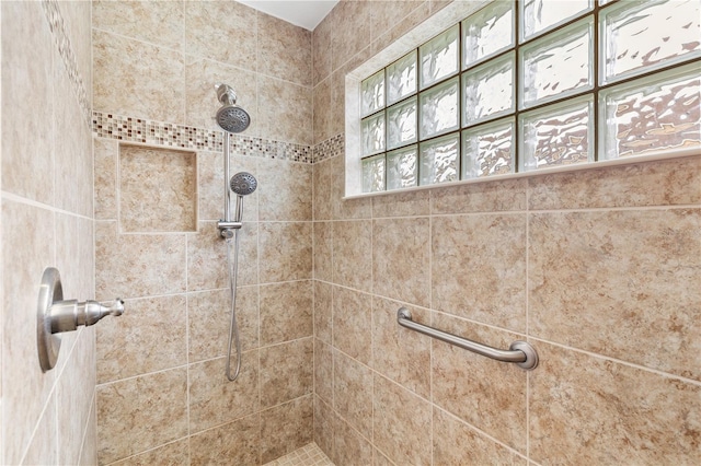 bathroom with tiled shower