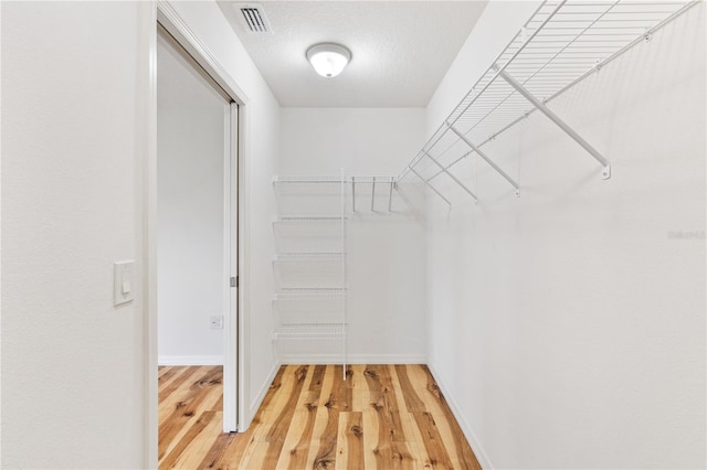 spacious closet featuring hardwood / wood-style floors