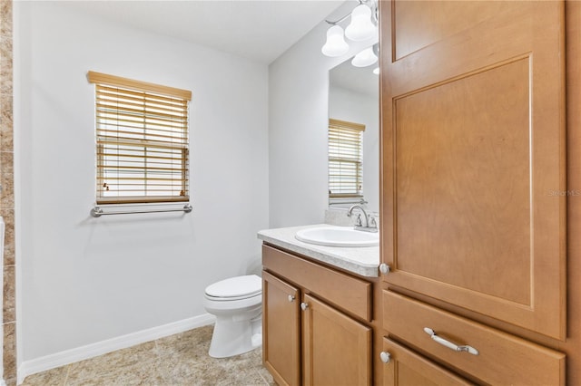 bathroom with tile patterned flooring, toilet, and vanity