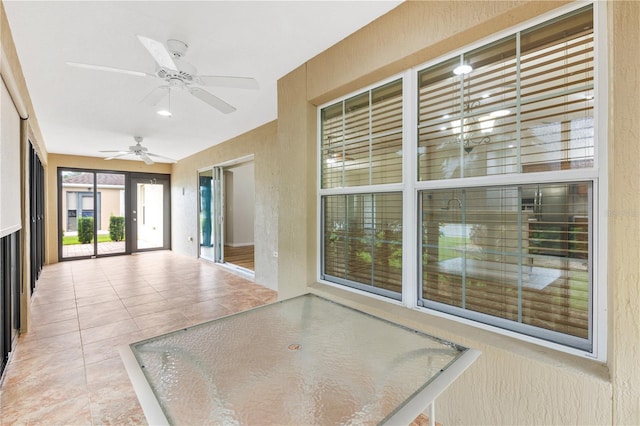 interior space with ceiling fan