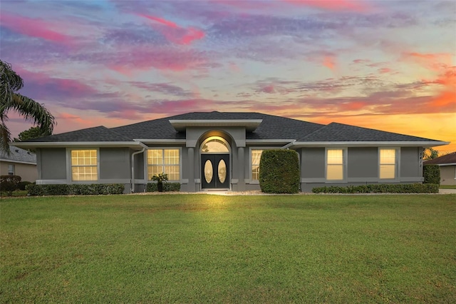 view of front of property with a lawn