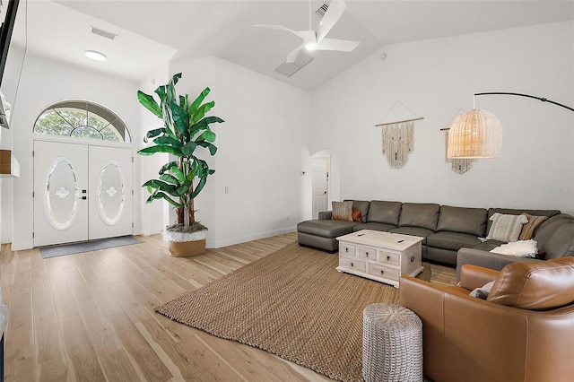 living room with washer / clothes dryer, hardwood / wood-style floors, vaulted ceiling, and ceiling fan