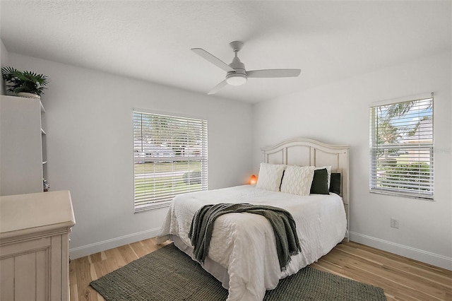 bedroom featuring light hardwood / wood-style floors and ceiling fan