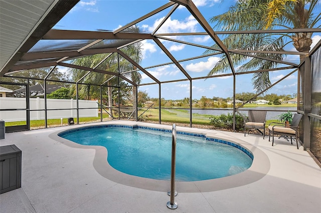 view of swimming pool featuring a patio, glass enclosure, and a water view