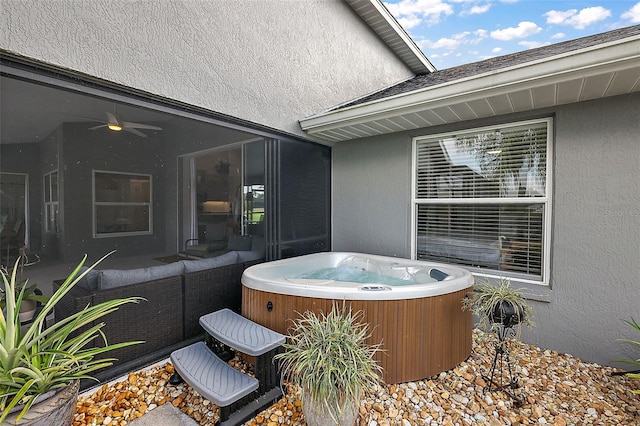 view of patio featuring a hot tub, central air condition unit, and ceiling fan