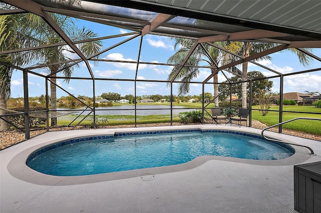 view of swimming pool with glass enclosure, a water view, and a patio