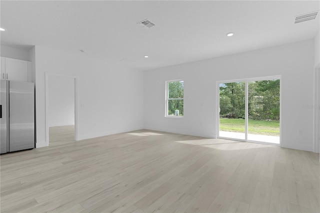 spare room with light hardwood / wood-style flooring