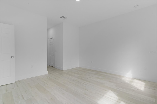 spare room featuring light hardwood / wood-style floors