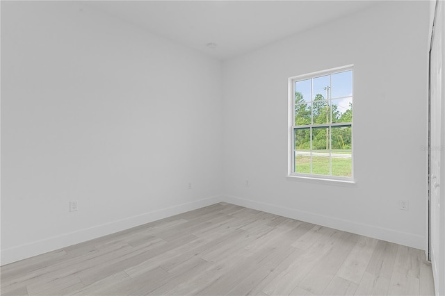 spare room with light wood-type flooring and a healthy amount of sunlight