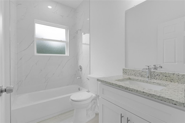 full bathroom with vanity, toilet, tiled shower / bath combo, and hardwood / wood-style flooring