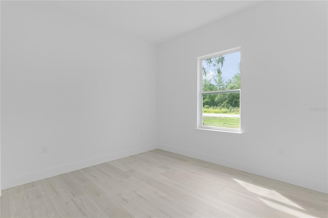 spare room with light hardwood / wood-style flooring