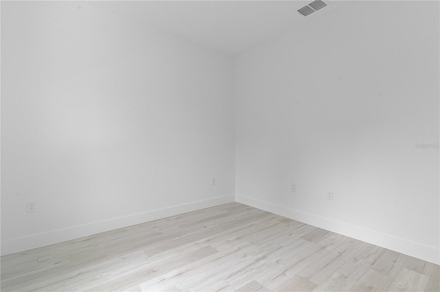 spare room with light hardwood / wood-style flooring