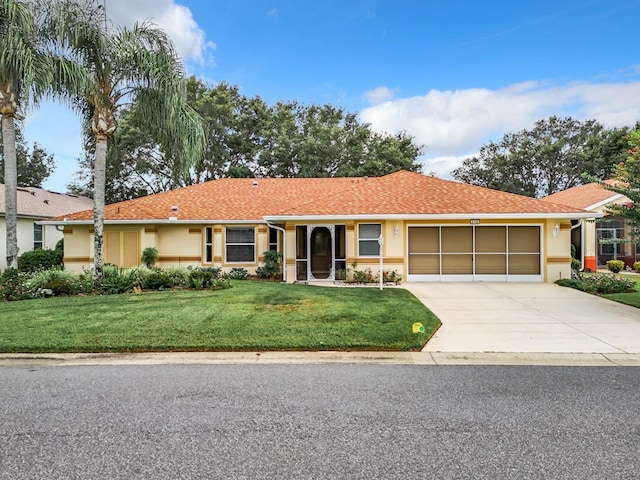 ranch-style house with a garage and a front yard