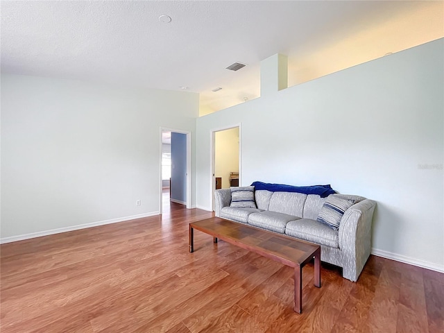 living room featuring a textured ceiling and hardwood / wood-style flooring