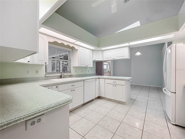 kitchen with white cabinets, white appliances, kitchen peninsula, and ceiling fan