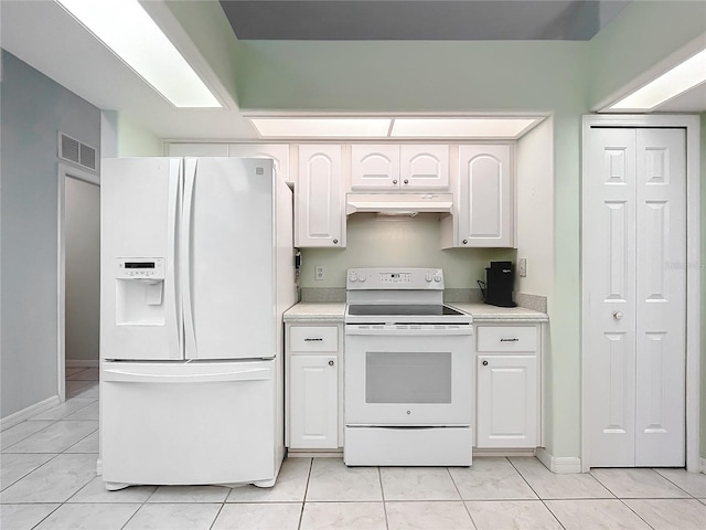 kitchen featuring white appliances, white cabinetry, and light tile patterned flooring