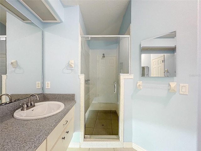 bathroom with vanity, an enclosed shower, and tile patterned floors