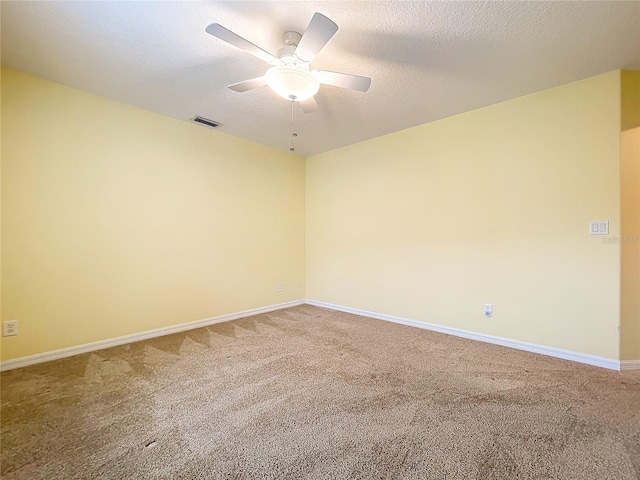 unfurnished room with ceiling fan, carpet, and a textured ceiling