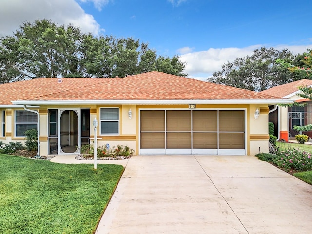 ranch-style home with a front lawn and a garage