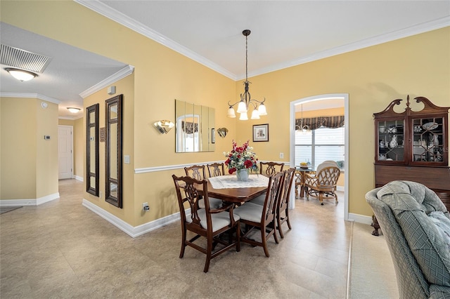 dining space featuring a chandelier and ornamental molding