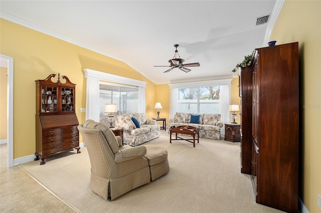 living room with ornamental molding, vaulted ceiling, light carpet, and ceiling fan