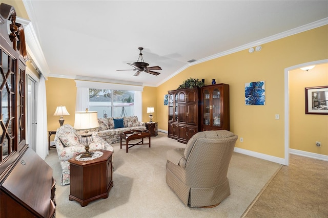 living room with ornamental molding, vaulted ceiling, ceiling fan, and light carpet