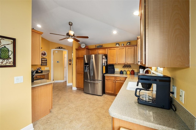 kitchen featuring ceiling fan, lofted ceiling, and stainless steel fridge with ice dispenser