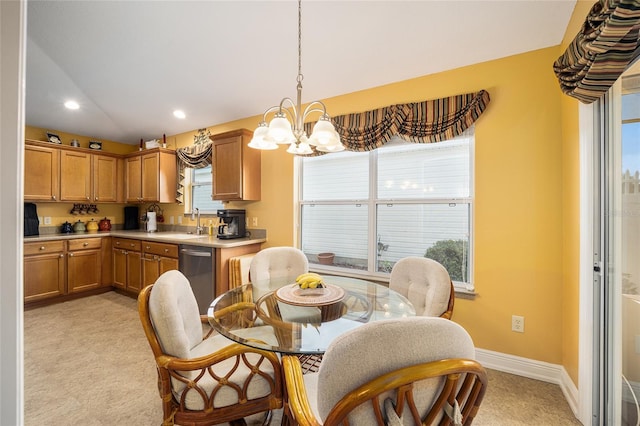 carpeted dining room featuring an inviting chandelier, plenty of natural light, and sink