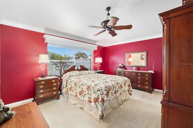 carpeted bedroom with ornamental molding and ceiling fan