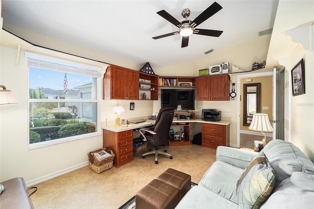 home office featuring vaulted ceiling, ceiling fan, and light colored carpet