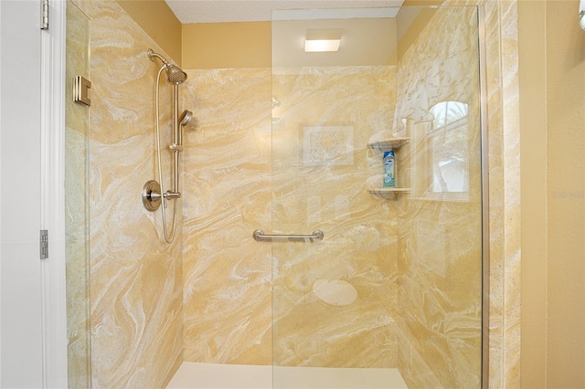 bathroom with a shower with door