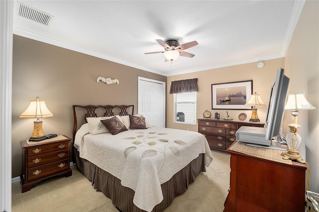 bedroom with ornamental molding, a closet, ceiling fan, and light carpet