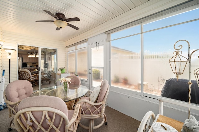 sunroom featuring ceiling fan