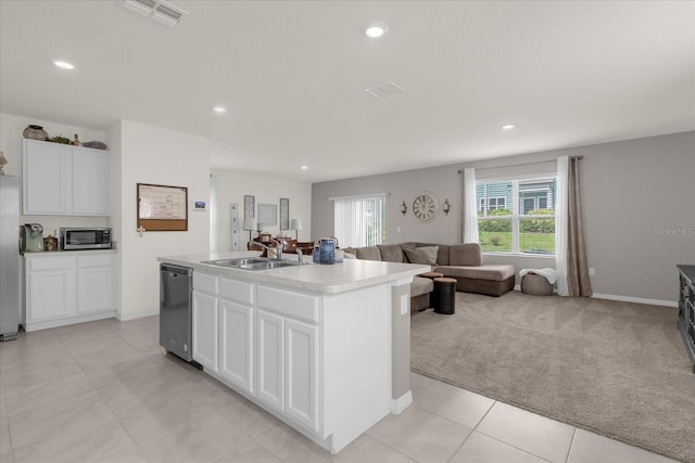 kitchen featuring a center island with sink, stainless steel appliances, sink, white cabinetry, and light colored carpet