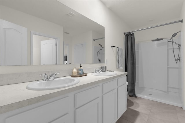 bathroom with vanity, a shower with curtain, and tile patterned flooring