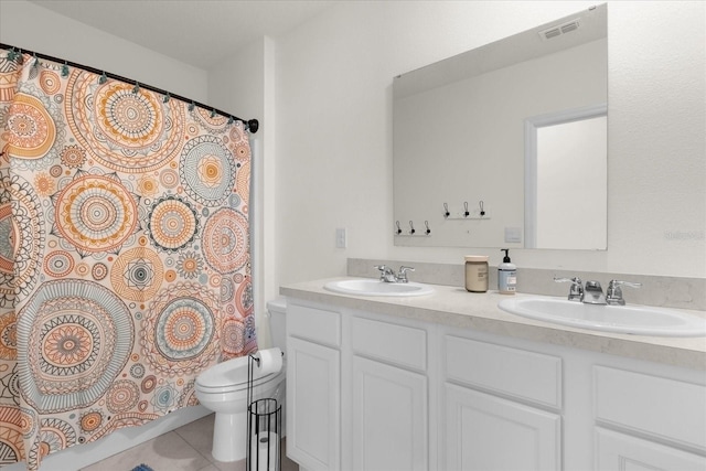 bathroom featuring vanity, toilet, walk in shower, and tile patterned flooring